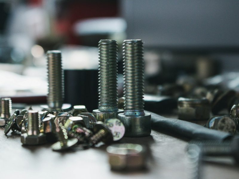 Hex bolts, nuts and screws on a workbench
