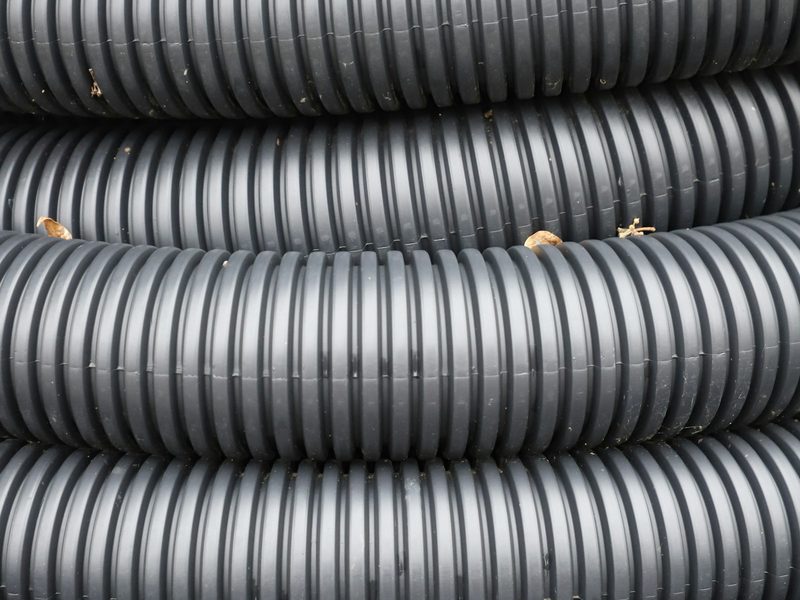 Coiled black corrugated plastic tubing