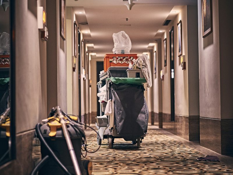 Janitorial cart and vacuum in a building corridor
