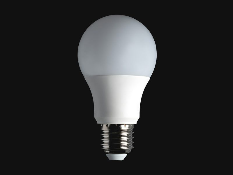 White LED light bulb against a black background
